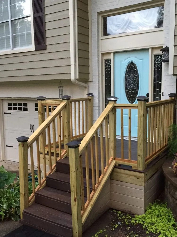 A custom-built backyard deck with railing and stairs